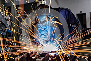 Industrial worker is welding in construction plant photo