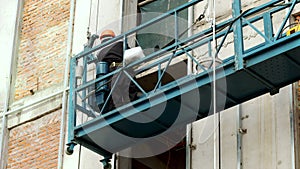 Industrial worker welding of metal structures, welder man male worker soldering steel beam structure on new building on