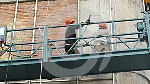 Industrial worker welding of metal structures, welder man male worker soldering steel beam structure on new building on