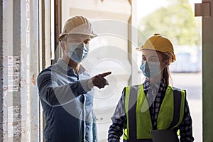 Industrial worker woman and engineer control worker checking in front door of cargo container at container cargo harbor