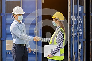 Industrial worker woman and engineer control worker checking in front door of cargo container at container cargo harbor