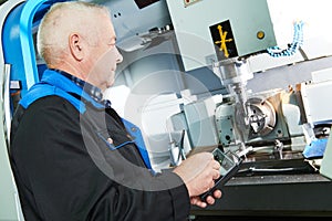 Industrial worker working with cnc milling machine