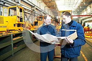 Industrial workers at assembling conveyer line