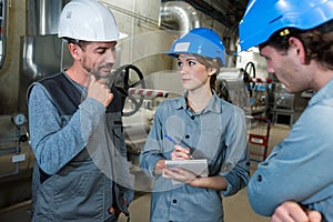 industrial workers checking welding metal profiles