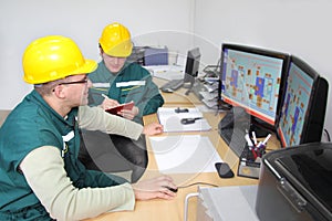 Industrial workers in a control room