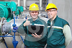 Industrial workers with notebook