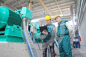 Industrial workers with notebook photo