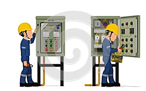 Industrial workers use clamp meter to measuring electric current in the electrical control cabinet
