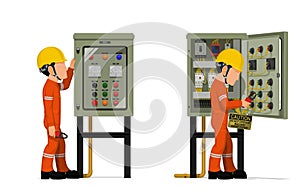 Industrial workers use clamp meter to measuring electric current in the electrical control cabinet