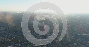 Industrial zone aerial view. Metallurgical plant at sunrise top view. Smoke from the chimney of a factory at sunset