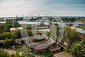 Industrial zone on the banks of the Volga, cranes, barges