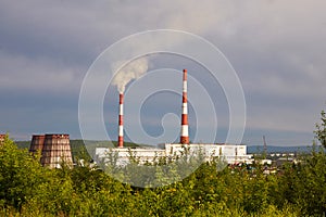 Industrial zone. The factory with pipes and smoke. The thermal power plant.