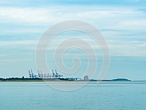 Industrialized area with visible cranes by the river bank