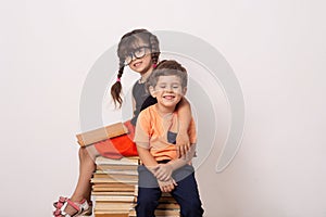 Industrious child boy and girl with books. Back to school creative background with school children. photo