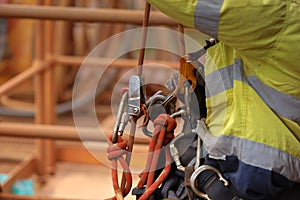 Industry abseiler worker working at height abseiling removing rope from chest harness croll safety device