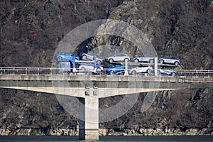 Industry and car transport. Car transporter. Car transporter truck crosses the bridge