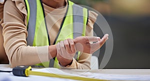 Industry, closeup and female construction worker with wrist pain, injury or accident in her office. Medical emergency