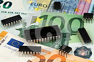 Industry Crisis Concept. Microchips global shortage. Microchips on Euro banknotes.