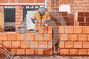 industry details - industrial bricklayer installing bricks on construction site