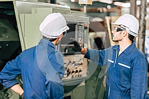 Industry engineer team worker operate control heavy machine with computer laptop to help analysis operating problem