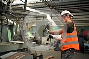 Industry engineer worker operate control heavy machine in factory.