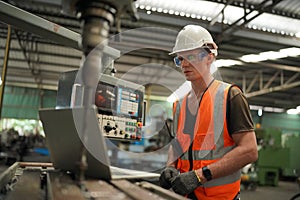 Industry engineer worker operate control heavy machine in factory.