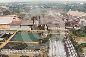 Industry factory manufacturing with pond of wastewater treatment