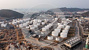 Industry factory oil and gas chemical tank and smoke with oil refinery plant zone and mountain ship in sea background