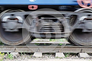 Industry, logistics, safety on transport concept. Motion blur of the undercarriage of a railroad car on the rails