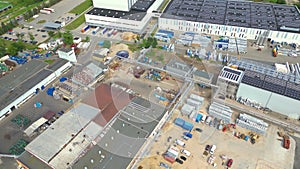 Industry with low carbon footprint. Industrial warehouses with solar panels on the roof. Technology park and factories from above