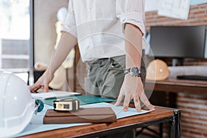 Industry manager, engineer, businessman reading and checking blueprint, drawing plan in the room in office