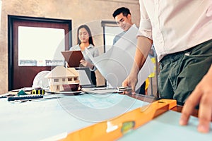 Industry manager, engineer, businessman reading and checking blueprint, drawing plan in the room in office