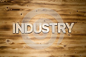 INDUSTRY word made of wooden block letters on wooden board