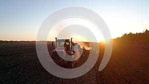 Industry of work rural land at farm sunset field by farming agriculture tractor