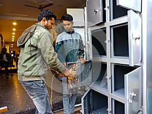 industry worker making iron Almira at workshop, operating electric steel cutter in India January 2020