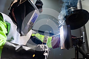 Industry worker welding a pieces of metal in the factory, weld concept