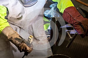 Industry worker welding a pieces of metal in the factory, weld concept