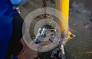 Industry worker welding steel structure at work background