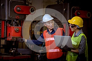 Industry worker woman under inspection and checking production process on factory station by laptop on hand ,Worker wearing casual