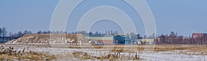 Industry zone with a sand mountain and a warehouse, Majoppeveld a dutch industrial terrain in the city of Roosendaal, The