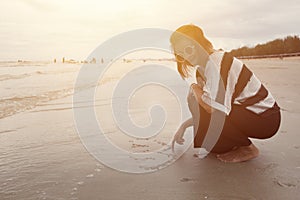 Indy women happy smile draw heart shape on the beach