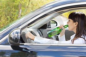 Inebriated female driver drinking alcohol