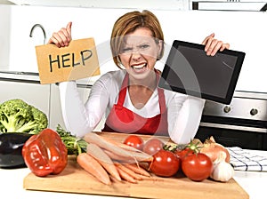 Inexperienced home cook woman in red apron screaming desperate and frustrated at domestic kitchen in stress