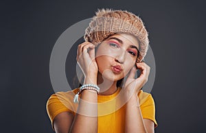 The infamous duckface. Cropped portrait of an attractive teenage girl wearing a beanie and feeling playful against a