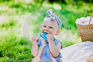 Infancy and age concept . beautiful happy baby in pink dress in the park playing