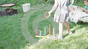 Infancy, childhood, picnic, educational games, development, summer holiday concept - kids playing Plastic Ring Toss