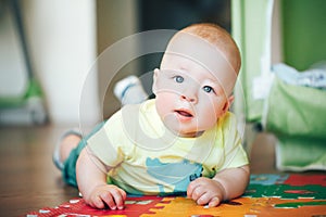 Infant Baby Child Boy Six Months Old is Playing on a Floor