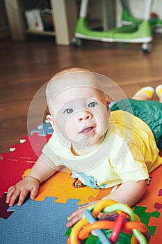 Infant Baby Child Boy Six Months Old is Playing on a Floor