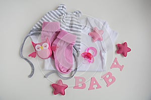 infant baby clothes baby girl pacifier cap on background