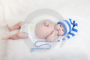 Infant baby dressed funny hat lying on a blanket